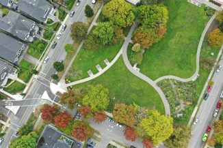an aerial view of a park with cars parked in it