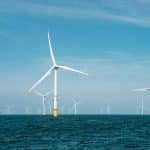 a group of wind turbines in the ocean