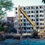 a construction site with a crane in the foreground