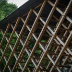 a wooden structure sitting in the middle of a forest