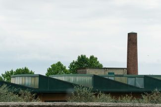 Industrial building with a tall brick chimney.