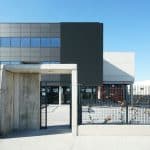 a gated entrance to a building with a building in the background