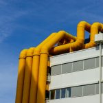 a building with yellow pipes on top of it