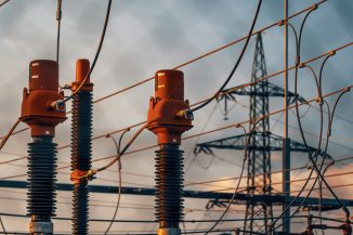 A row of power lines with a sky in the background