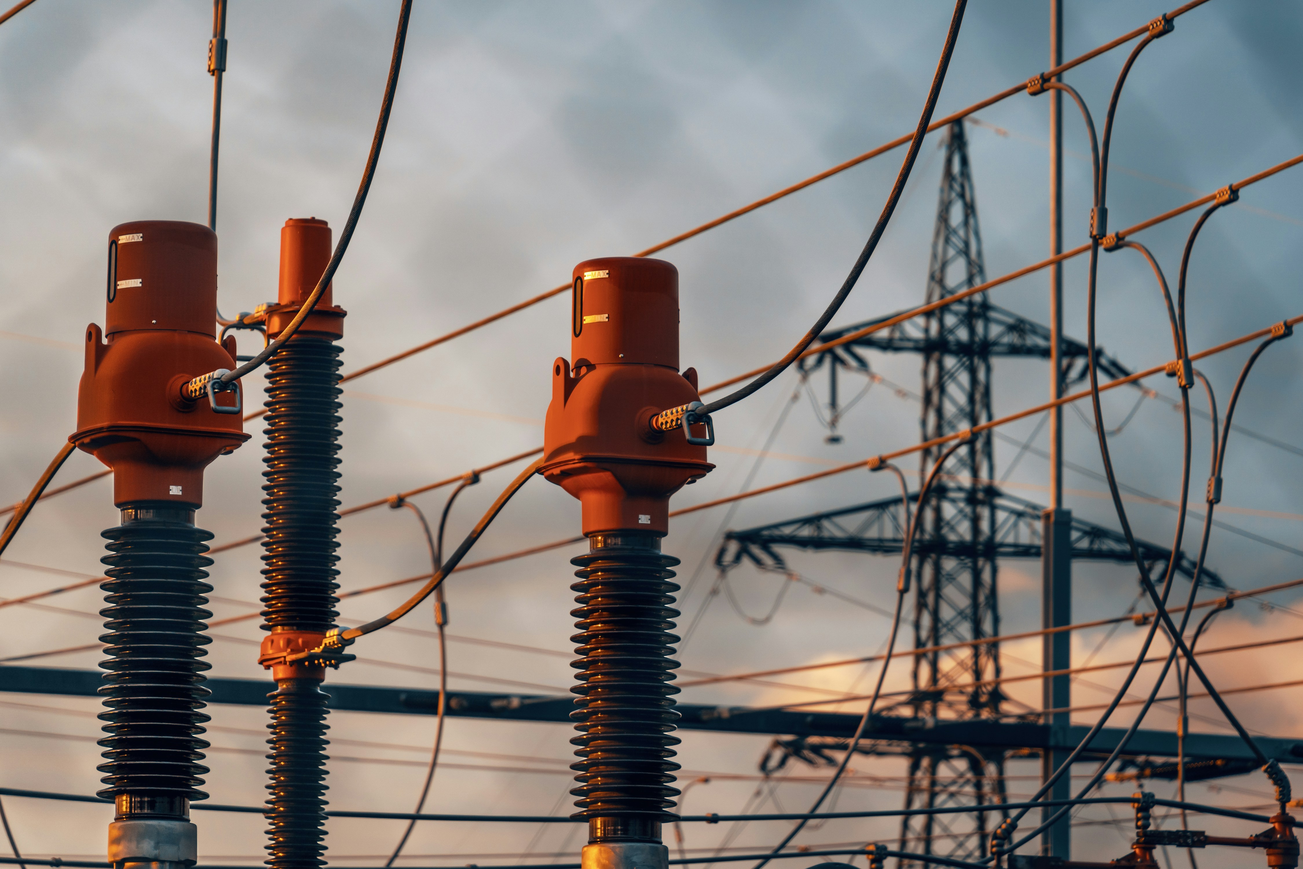 A row of power lines with a sky in the background