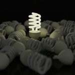 a white light bulb surrounded by many gray objects