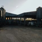 Farm buildings with silos and livestock pens.