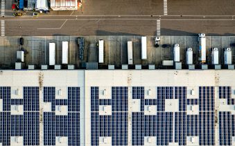 An aerial view of a parking lot with lots of solar panels