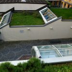 a house with a green roof and a green roof