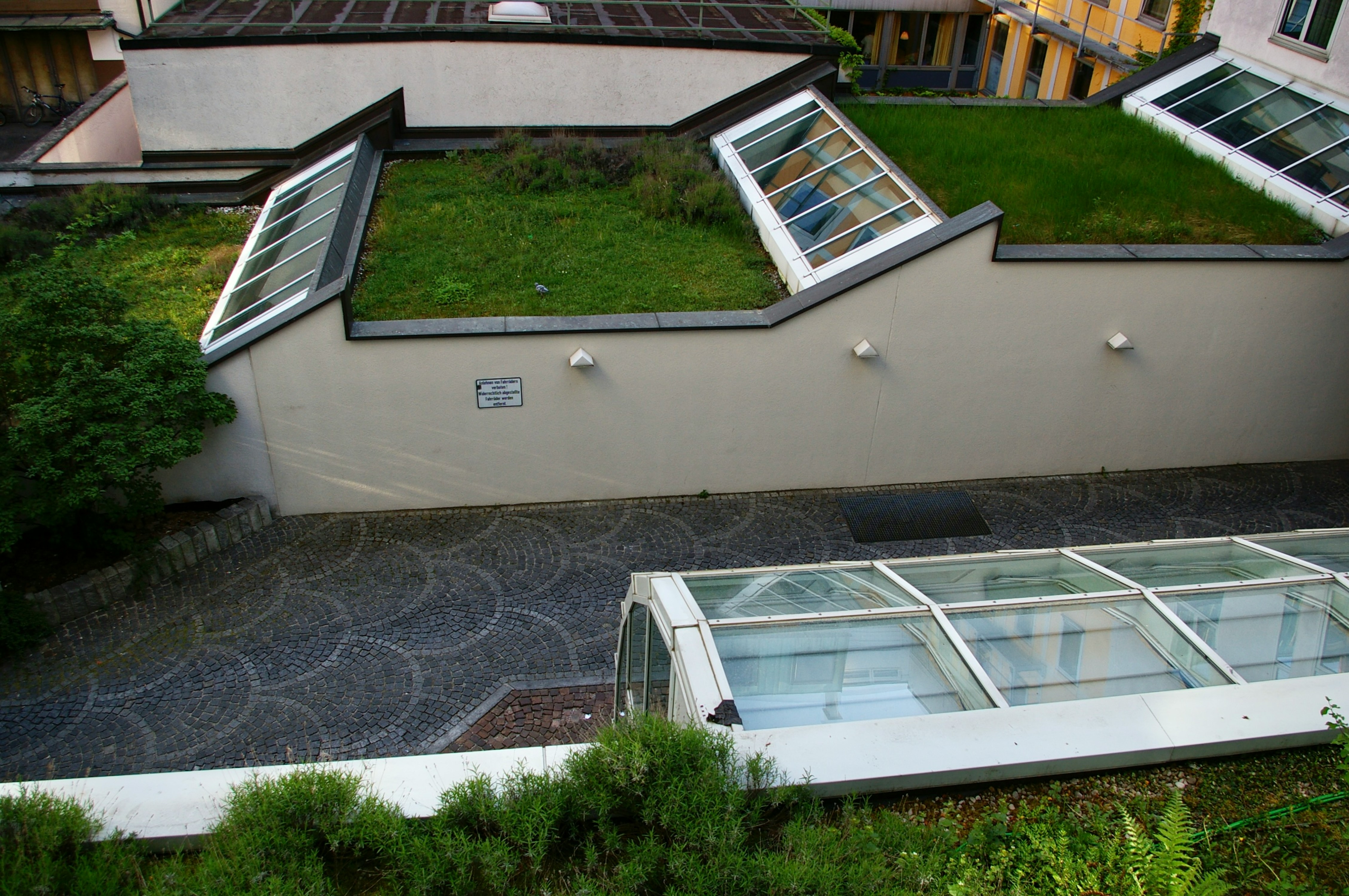 a house with a green roof and a green roof
