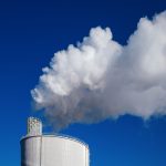 a smokestack emits from the top of a building