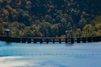 Dam structure with trees in the background
