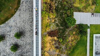 Aerial view of a modern landscape with greenery and paving.
