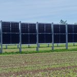 a row of solar panels in a field