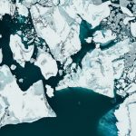 white ice on body of water during daytime