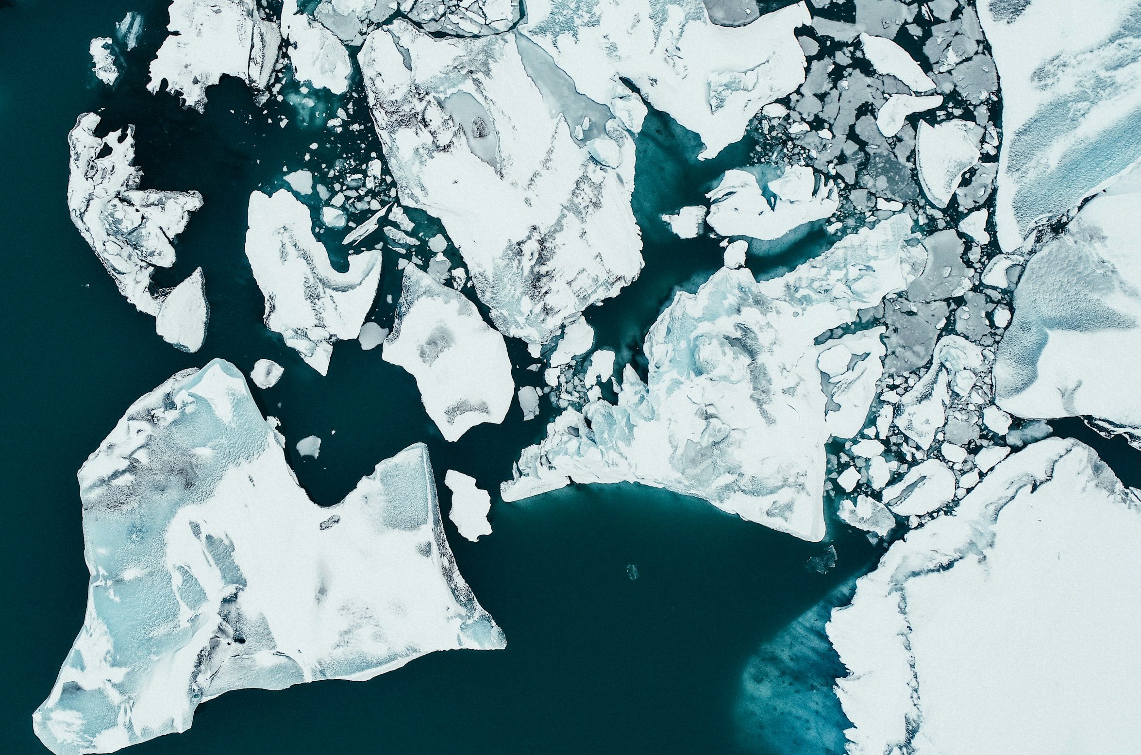 white ice on body of water during daytime