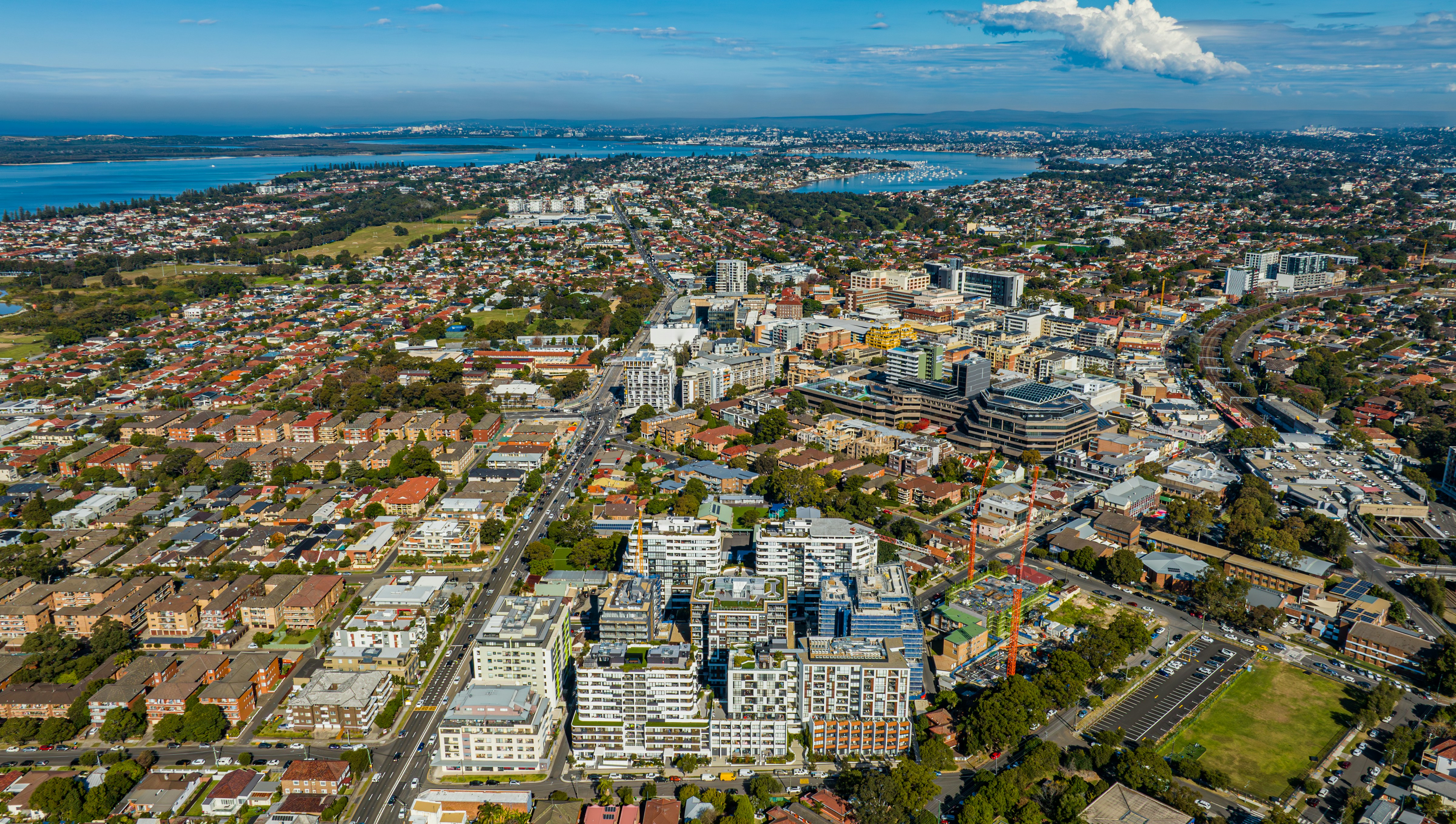 Aerial view of a sprawling urban cityscape with modern buildings.