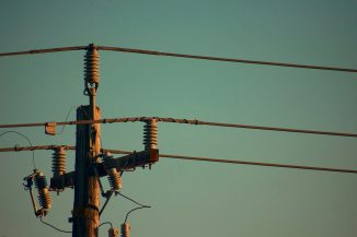 three electric cables on electric post