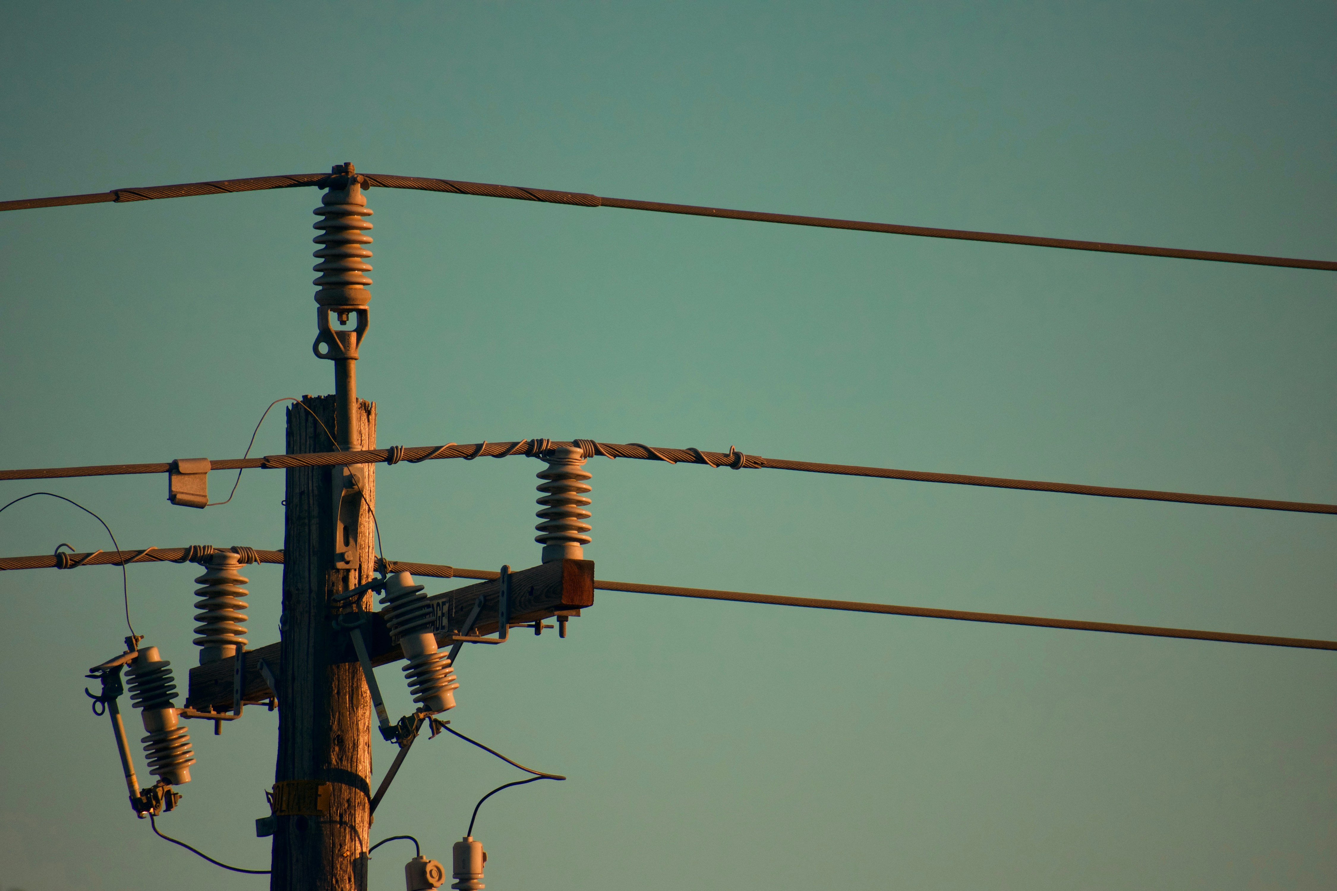 three electric cables on electric post