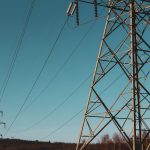 brown electric post under blue sky during daytime